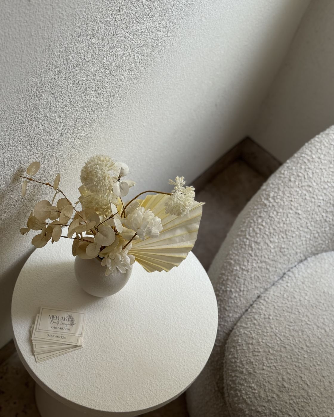 A boucle chair and side table in Kasey's studio